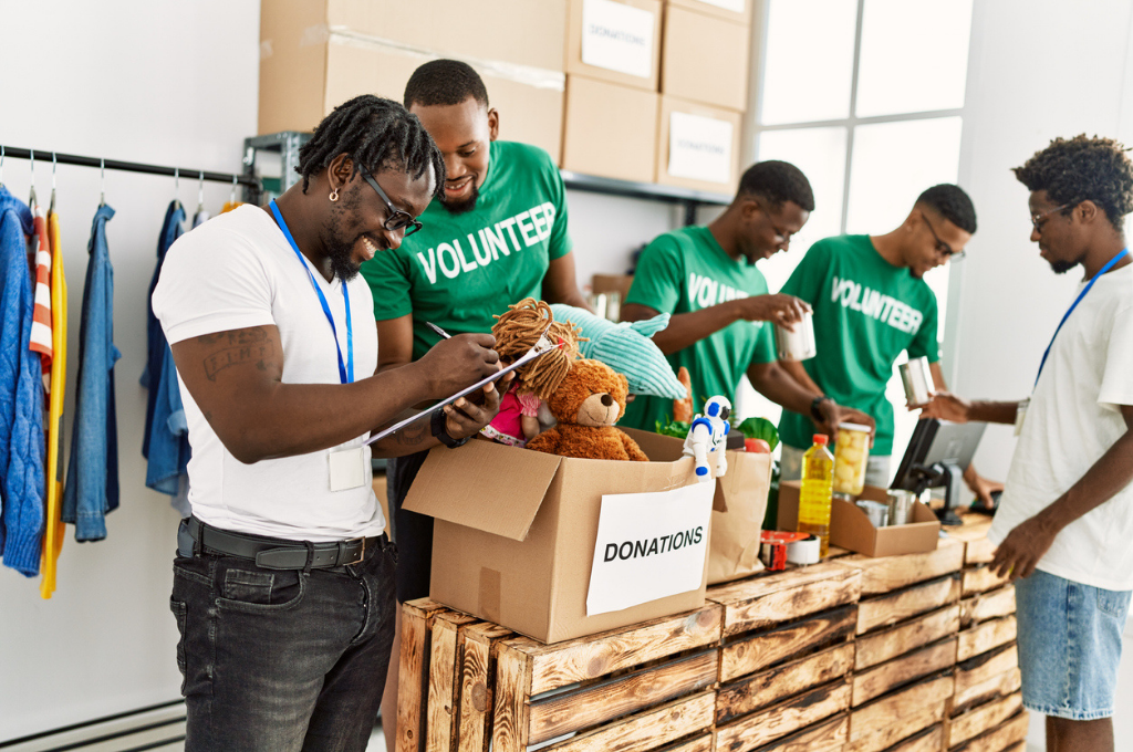 Volunteers sorting and packing donated items like toys and canned goods.