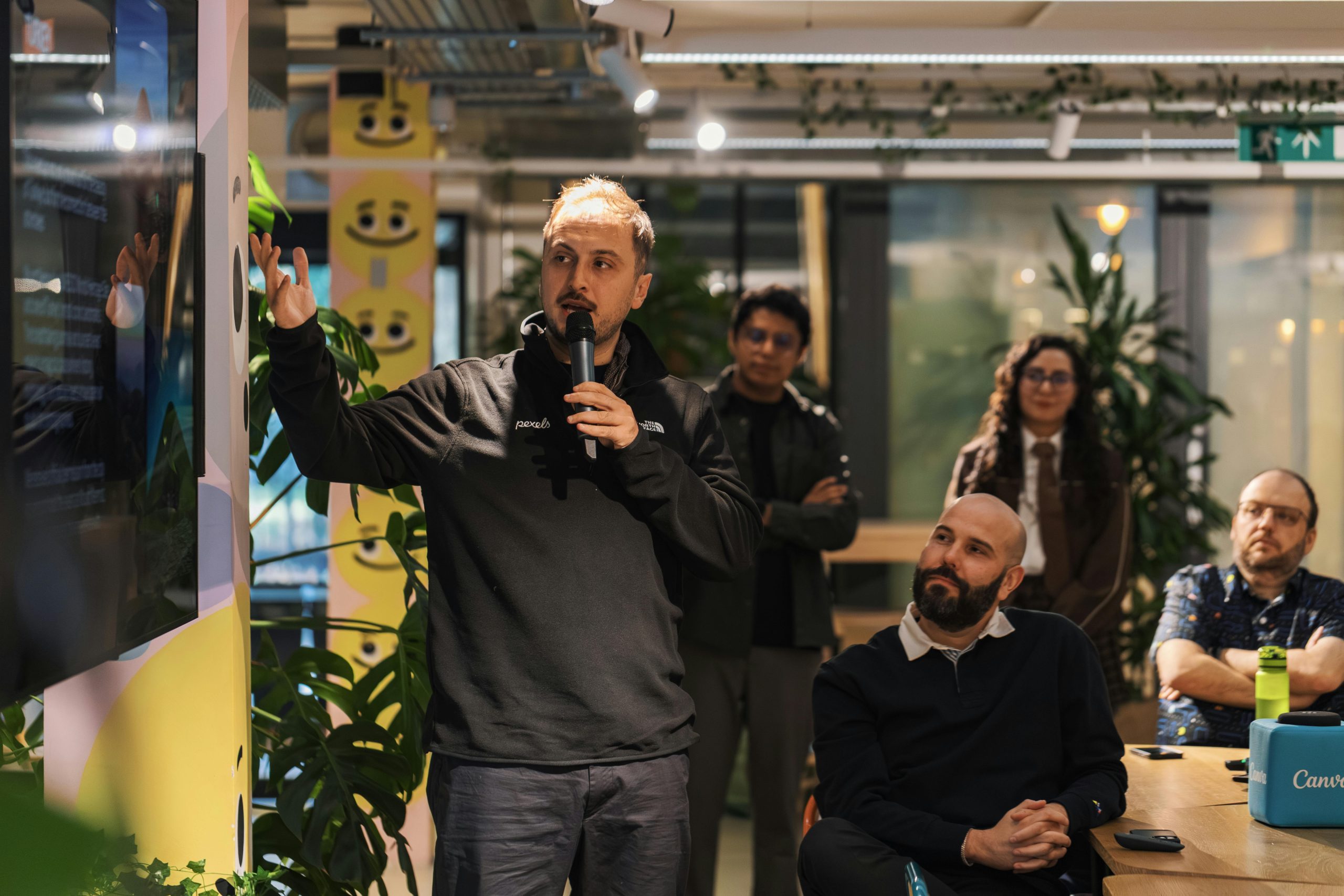 A man gives a speech in a corporate setting